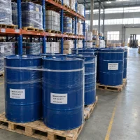 1-methylimidazole-cas-616-47-7-blue-steel-drums-pallet Blue steel drums labeled 1-Methylimidazole CAS 616-47-7 on wooden pallets in a warehouse with storage racks and IBC tanks behind.