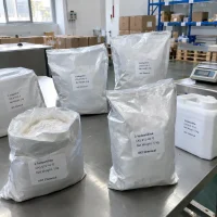 2-iodoaniline-cas-615-43-0-5kg-foil-bags-packing Silver foil bags of 2-Iodoaniline CAS 615-43-0 with 5 kg net weight on a stainless steel packing table, one open bag showing white powder, beside a plastic jar and a scale.