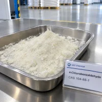4-chlorobenzaldehyde-crystals-stainless-tray-display 4-Chlorobenzaldehyde (CAS 104-88-1) white crystalline powder in a stainless steel tray with a UAT Chemical sign card