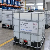 IBC tanks labeled 4-Vinylaniline (4-Aminostyrene) CAS 1520-21-4 with approx 1000 L net content and flammable hazard labels in a warehouse with racks of blue drums behind.