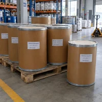 Several brown fiber drums of Aluminum Chlorohydrate CAS 12042-91-0 on a wooden pallet in a warehouse with a manual pallet jack nearby.