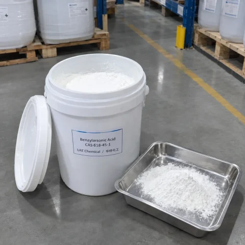 White powder of benzylarsonic acid (CAS 618-45-1) in an open plastic pail and stainless steel tray, UAT Chemical label