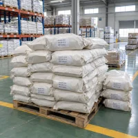 brassylic-acid-cas-505-52-2-woven-bags-pallet White woven bags of brassylic acid (CAS 505-52-2) labeled UAT Chemical stacked in two piles on pallets in a warehouse