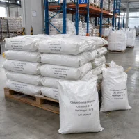 Calcium chloride dihydrate (CAS 10035-04-8) packed in 25 kg white woven bags stacked on a wooden pallet in a warehouse