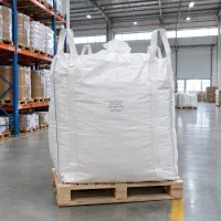 Large white FIBC bag labeled Calcium Phytate CAS 3615-82-5 with 500 kg net weight on a wooden pallet in a warehouse.