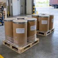 Kraft fiber drums labeled Caryophyllene Oxide (CAS 1139-30-6) shrink-wrapped on wooden pallets at a loading dock