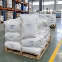 Stacked white woven bags of chloroacetamide (CAS 79-07-2), 25 kg each, on a wooden pallet