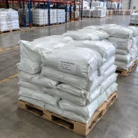 Stacked 25kg white bags of Chromium(III) Sulfate CAS 10101-53-8 on wooden pallets in a warehouse storage area.