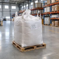 ferric-oxide-red-iron-oxide-cas-1309-37-1-500kg-fibc-bag-pallet Large white FIBC bag labeled Ferric Oxide Red Iron Oxide CAS 1309-37-1 with 500 kg net weight on a wooden pallet in a warehouse.