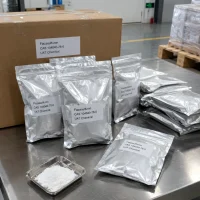 flazasulfuron-cas-104040-78-0-aluminum-foil-bag-packaging Silver aluminum foil pouches labeled flazasulfuron (CAS 104040-78-0) on a stainless steel table with a powder sample in a metal dish