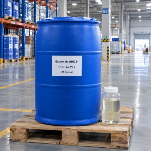 Galaxolide (HHCB, CAS 1222-05-5) liquid in a blue drum on a pallet with a glass bottle of clear sample beside it