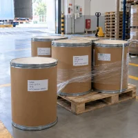indole-25kg-fiber-drums-pallet-loading-dock Indole (CAS 120-72-9) in 25 kg fiber drums on a pallet, partly stretch-wrapped, at a warehouse loading dock