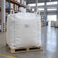 l-theanine-cas-3081-61-6-500kg-fibc-bulk-bag-pallet Large white FIBC bag labeled L-Theanine CAS 3081-61-6 with 500 kg net weight on a wooden pallet in a warehouse.