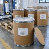 lithium-carbonate-cas-554-13-2-25kg-fiber-drums-open-drum 25kg brown fiber drums of Lithium Carbonate CAS 554-13-2 with one open drum showing inner liner and its lid beside, near packaging equipment in a factory.