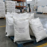 lithium-carbonate-cas-554-13-2-25kg-woven-bags-pallet 25kg white woven bags of Lithium Carbonate CAS 554-13-2 on a blue plastic pallet in a warehouse with racks and bagged stock in the background.