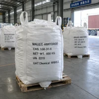 maleic-anhydride-cas-108-31-6-600kg-fibc-bulk-bags-pallet White FIBC bulk bags labeled Maleic Anhydride CAS 108-31-6 UN 2215 with 600 kg net weight on wooden pallets at a warehouse loading area with a container truck behind.
