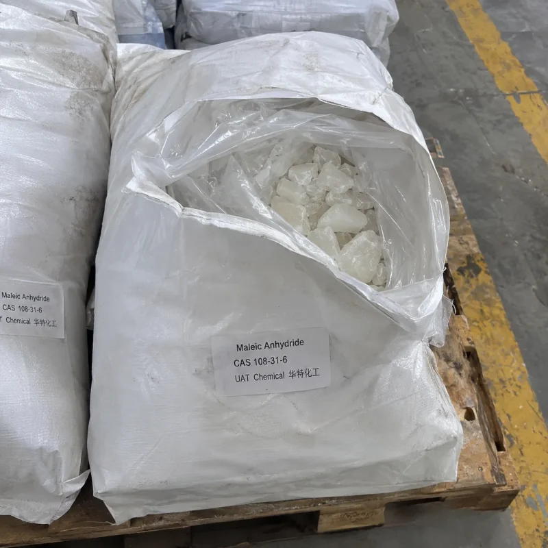 maleic-anhydride-cas-108-31-6-white-crystals-open-bag Open white woven bag showing white Maleic Anhydride crystals CAS 108-31-6 in an inner plastic liner on a wooden pallet in a warehouse.