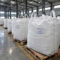 Row of white FIBC bulk bags labeled Melamine Cyanurate MCA CAS 37640-57-6 on wooden pallets in a warehouse.