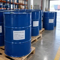 Blue steel drums of monoethanolamine oleate (CAS 2272-11-9), 200 kg each, standing on wooden pallets in a warehouse