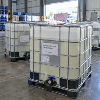 neodecanoic-acid-cas-26896-20-8-ibc-totes-liquid Neodecanoic acid CAS 26896-20-8 liquid in IBC tote tanks in warehouse with container truck outside