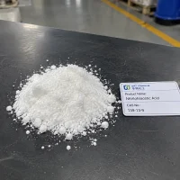 Pile of white Nitrilotriacetic Acid NTA powder CAS 139-13-9 on a dark table with a product label card in a factory.