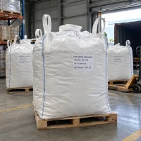 phenylethyl-resorcinol-cas-85-27-8-1000kg-ton-bag Large white ton bags of Phenylethyl Resorcinol CAS 85-27-8, net weight 1000 kg, on wooden pallets near a shipping container.