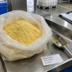 Poly ferric sulfate CAS 35139-28-7 yellow powder in open PE bag with steel scoop and label card on table