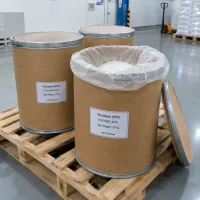 Povidone (PVP, CAS 9003-39-8) in 25 kg fiber drums on a pallet, one open drum showing white powder inside