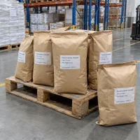 tetrachlorophthalic-anhydride-cas-117-08-8-25kg-paper-bags-pallet Stacked 25kg brown paper bags of Tetrachlorophthalic Anhydride CAS 117-08-8 on a wooden pallet in a warehouse.
