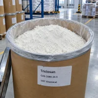 Triclosan (CAS 3380-34-5) white powder in an open fiber drum with plastic liner, close-up view in a warehouse